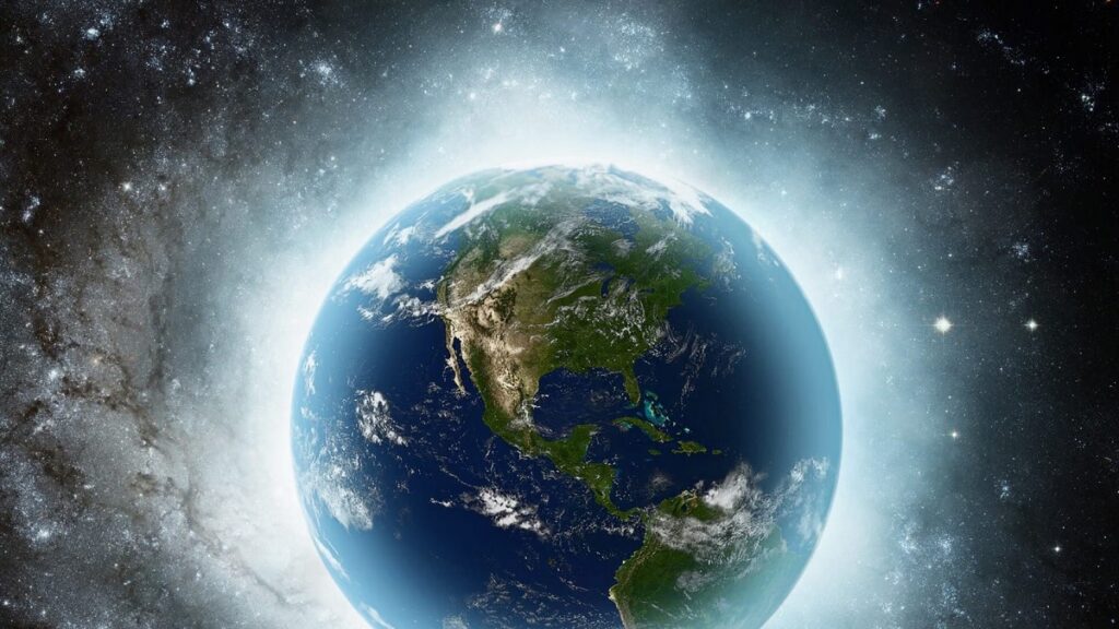 How Earth’s Violent Birth Left It Ready for Life Earth as seen from space, with a bright glow around it and a starry background (North America visible).